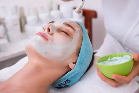 Facial mask treatment with a bowl of cream
