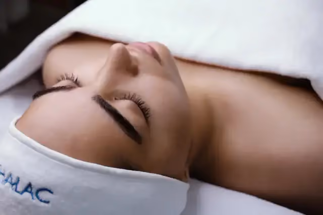 Woman relaxing during a spa facial treatment