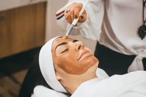 Therapist applying a clay mask treatment