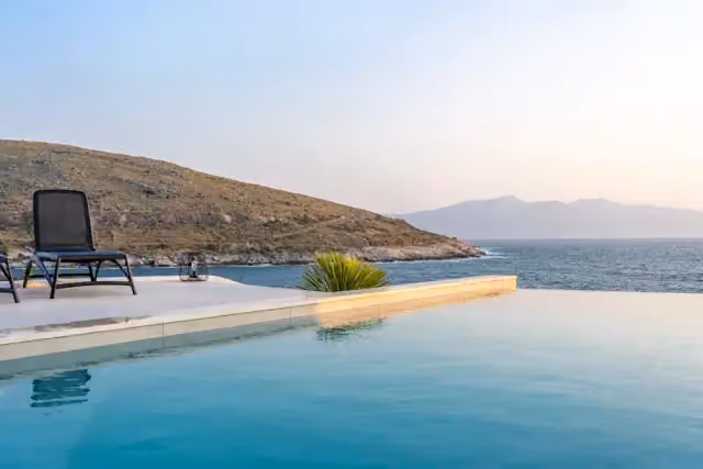 Infinity pool above a calm sea at dusk